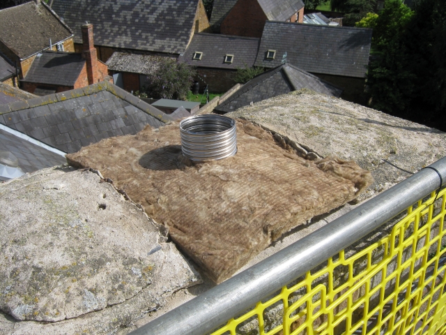 Chimney lining insulated during new woodburning stove installation