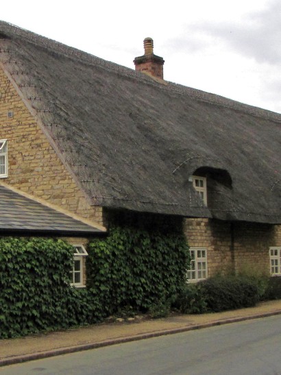 Chimney in need of raising above thatched roof