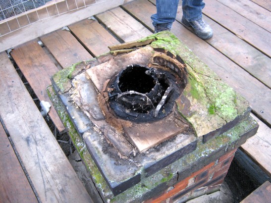 Unsafe wood chimney lining support in thatched property near Stamford