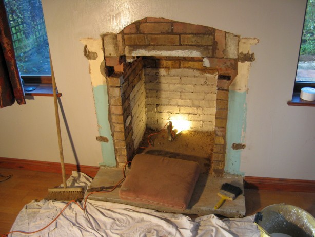 The builder is creating a new fireplace aperture