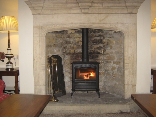New efficient Franco-Belge Savoy 8kW multifuel stove installed in stone fireplace by Fotheringhay Woodburners