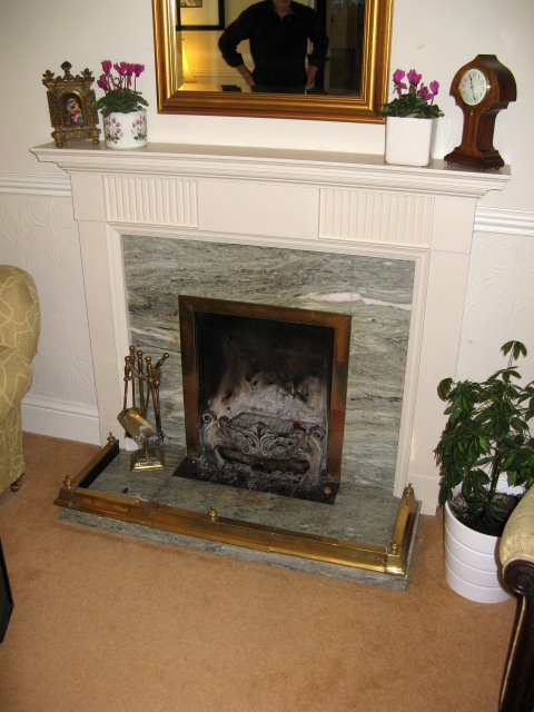 Open fire replaced with Woodwarm inset stove and bespoke stone fireplace