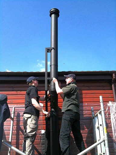 Installing the bespoke flue bracket made in Fotheringhay Woodburners' workshop