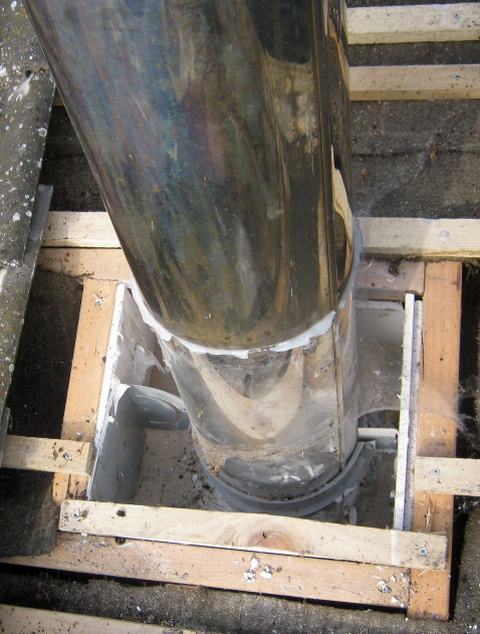 Badly installed twin wall insulated stainless steel system chimney being removed by Fotheringhay Woodburners