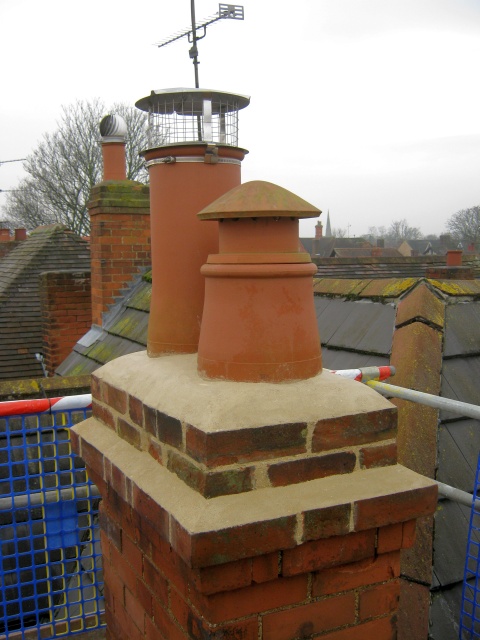 Rebuilt chimney with new chimney lining installed and new chimney pots and vent cap fitted on the disused flue