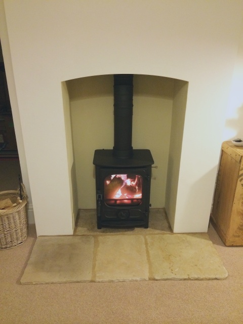 Old unattractive red brick fireplace and gas fire removed and replaced with efficient Charnwood multifuel stove by Fotheringhay Woodburners