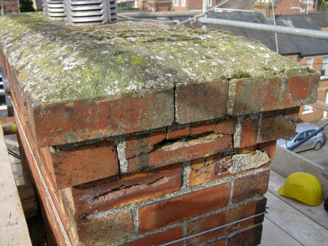 Weather damaged bricks on chimney stack before rebuilding by Fotheringhay Woodburners builder