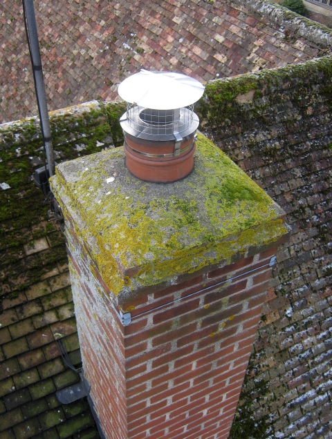 Chimney lined with flexible stainless steel liner during installation of Woodwarm stove