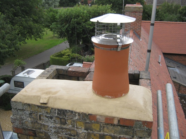 New flue liner and new chimney pot installed with stainless steel pothanger and birdguard cowl by Fotheringhay Woodburners