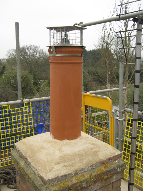 New stainless steel chimney liner fitted with pot hanger and cowl by the Fotheringhay Woodburners HETAS engineer