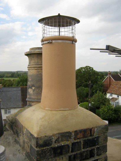 New chimney with painted bird guard to minimise visual impact
